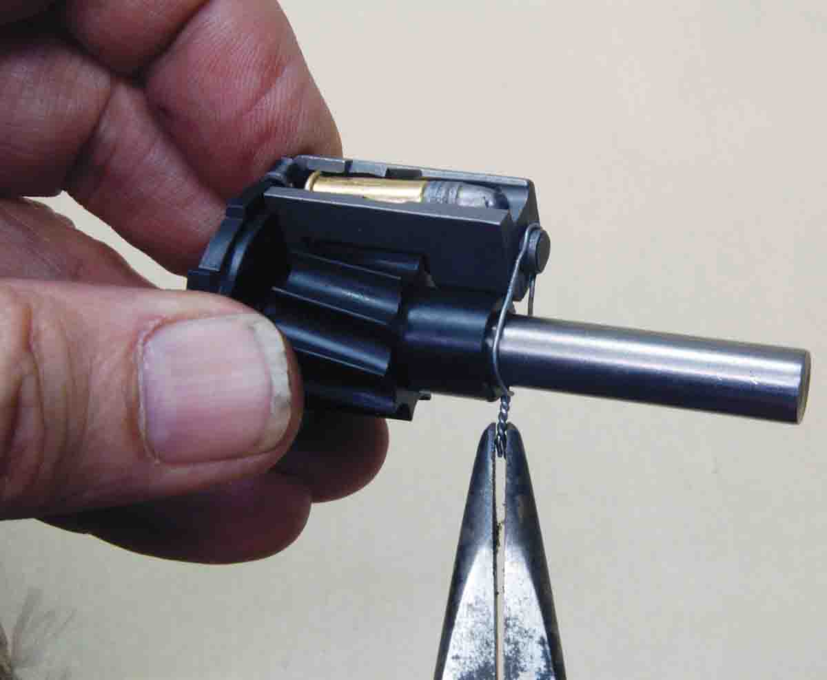The rotor is turned to fully loaded position. The front of the magazine throat must touch the front of the rotor or be wired down as shown.